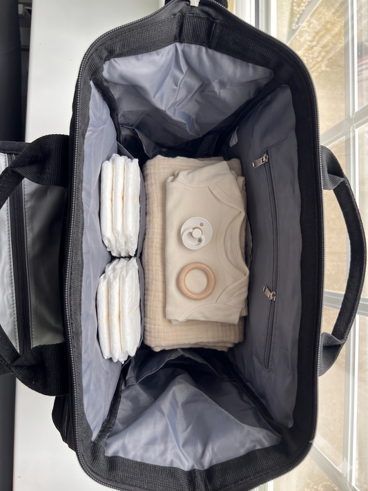 NestnGo changing bag main compartment wide open showing interior pockets — Charcoal Black