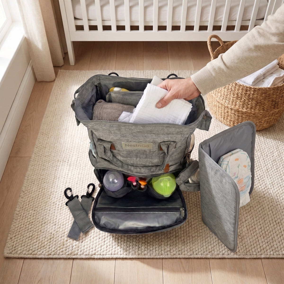 A dad seen from behind wearing the NestnGo changing bag, beside a pram