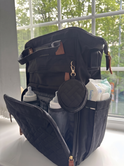 NestnGo nappy bag lifestyle — parent using bag at outdoor location with baby
