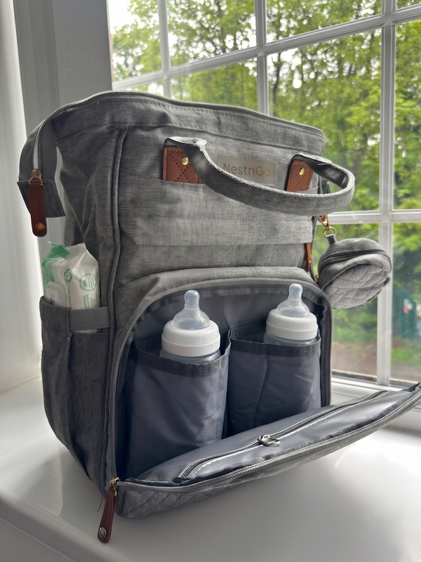 NestnGo baby changing backpack lifestyle shot — parent carrying bag on pushchair