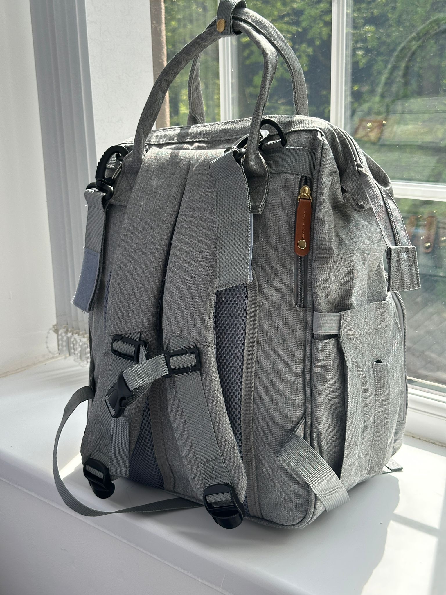 NestnGo grey changing bag backpack — side profile with padded shoulder straps