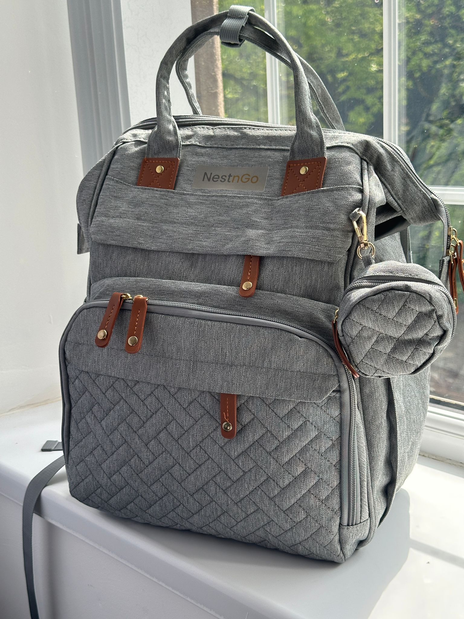 NestnGo 3-in-1 changing bag backpack in grey — front view showing quilted water-resistant fabric